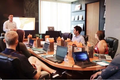 5 people seated around a conference table