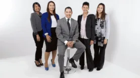 5 people in business attire in a white room