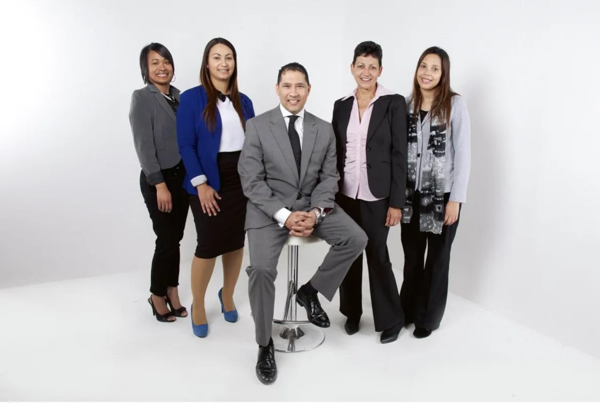 5 people in business attire in a white room