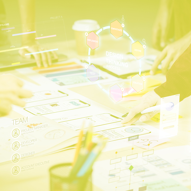 Design thinking: desk covered with paper design prototypes.